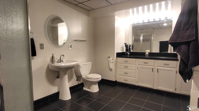 bathroom with toilet, a shower with shower door, and tile patterned flooring