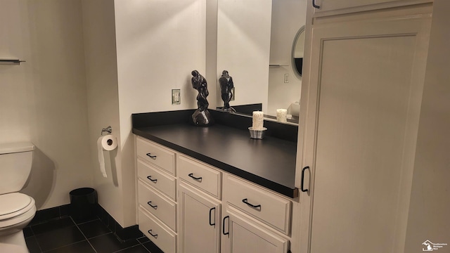 bathroom featuring vanity, tile patterned flooring, and toilet