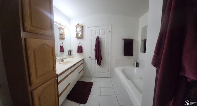 bathroom featuring tile patterned flooring, a bathing tub, and vanity