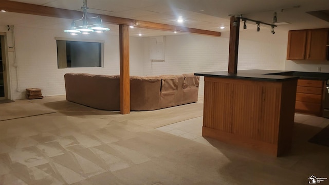 basement featuring brick wall and light carpet