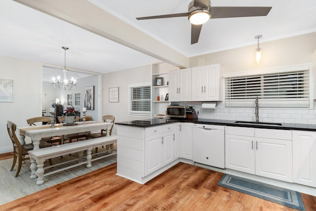 kitchen featuring dishwasher, sink, tasteful backsplash, white cabinets, and light wood-type flooring