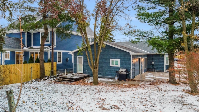 view of snow covered back of property