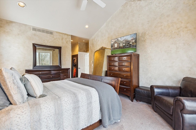 bedroom with ceiling fan, high vaulted ceiling, and light carpet