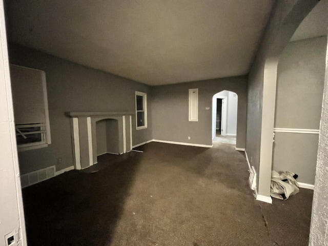 unfurnished living room with dark carpet