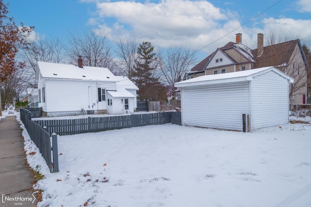 view of snow covered back of property