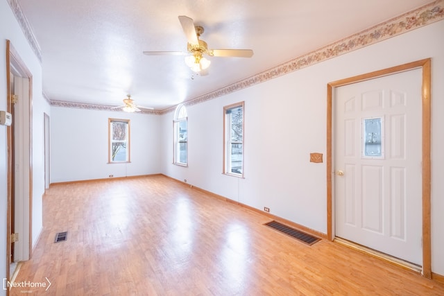 entryway featuring light wood-type flooring, ceiling fan, and ornamental molding