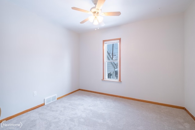 unfurnished room with light carpet and ceiling fan