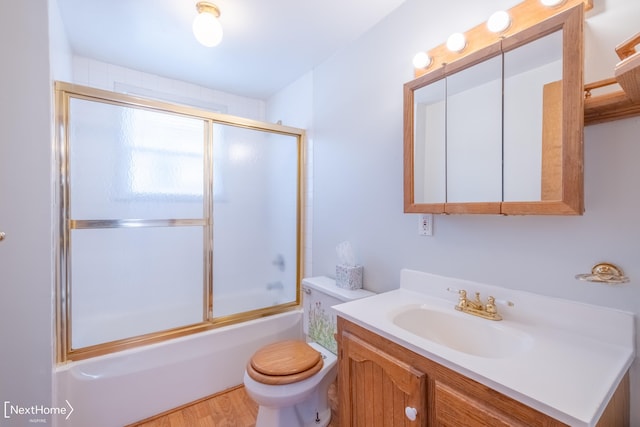 full bathroom with shower / bath combination with glass door, wood-type flooring, vanity, and toilet