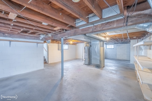 basement featuring heating unit and water heater