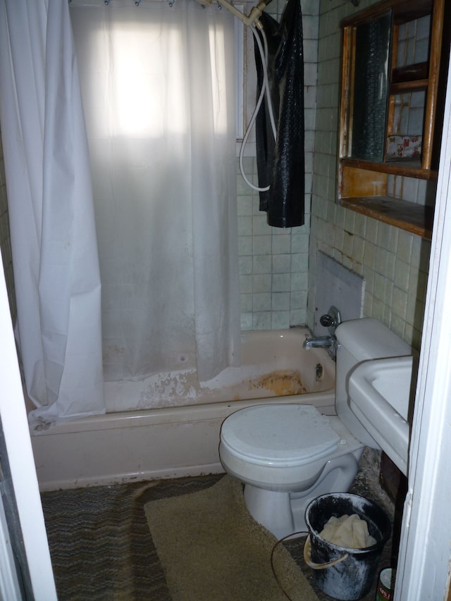 bathroom with shower / tub combo, tile walls, and toilet