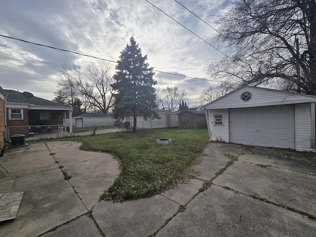 view of yard featuring a shed, cooling unit, and a garage