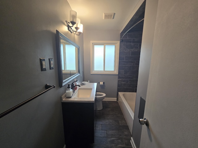 full bathroom with vanity, tiled shower / bath combo, a notable chandelier, and toilet