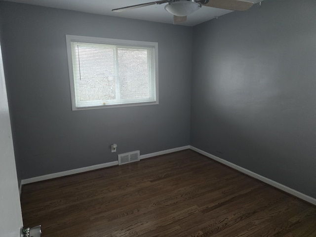 empty room featuring dark hardwood / wood-style floors and ceiling fan