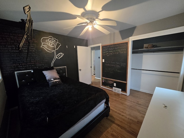 bedroom with ceiling fan and wood-type flooring