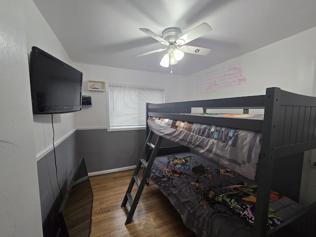 bedroom with dark hardwood / wood-style floors and ceiling fan