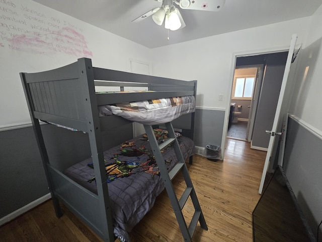 bedroom with ceiling fan and dark wood-type flooring