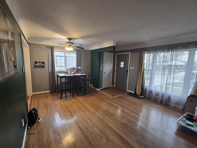 dining room with hardwood / wood-style flooring, ceiling fan, and a textured ceiling