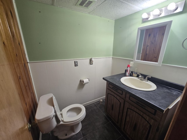 bathroom featuring tile patterned flooring, vanity, and toilet