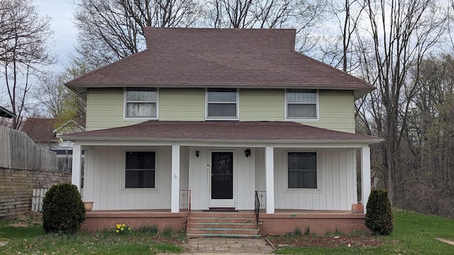 2521 Hillside Dr NW, Grand Rapids, MI 49544 - traditional style home with fence, covered porch, and roof with shingles