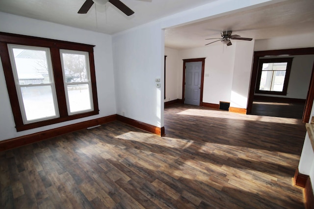 unfurnished room with ceiling fan, dark hardwood / wood-style flooring, and a healthy amount of sunlight