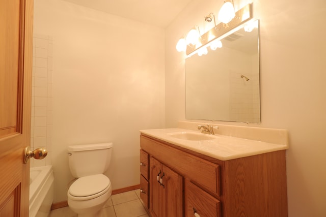 bathroom with toilet, vanity, and tile patterned floors