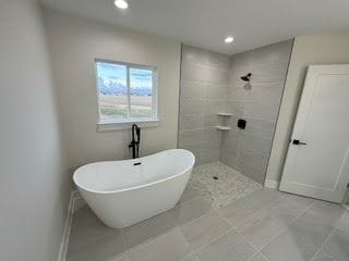 bathroom featuring separate shower and tub and tile patterned flooring