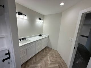 bathroom featuring vanity and parquet floors