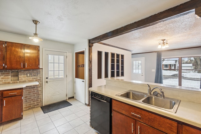 kitchen featuring a wealth of natural light, sink, pendant lighting, and black dishwasher