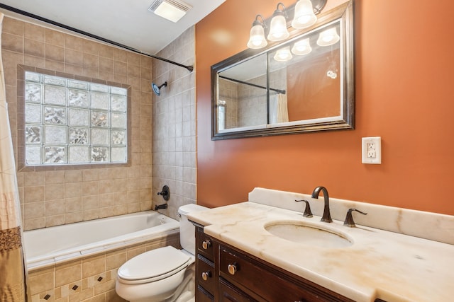 full bathroom featuring vanity, shower / bath combination with curtain, and toilet