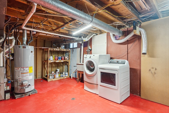 basement with washer and clothes dryer and gas water heater