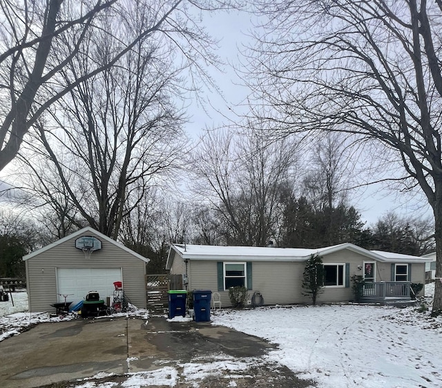 view of snowy exterior featuring a garage and an outdoor structure