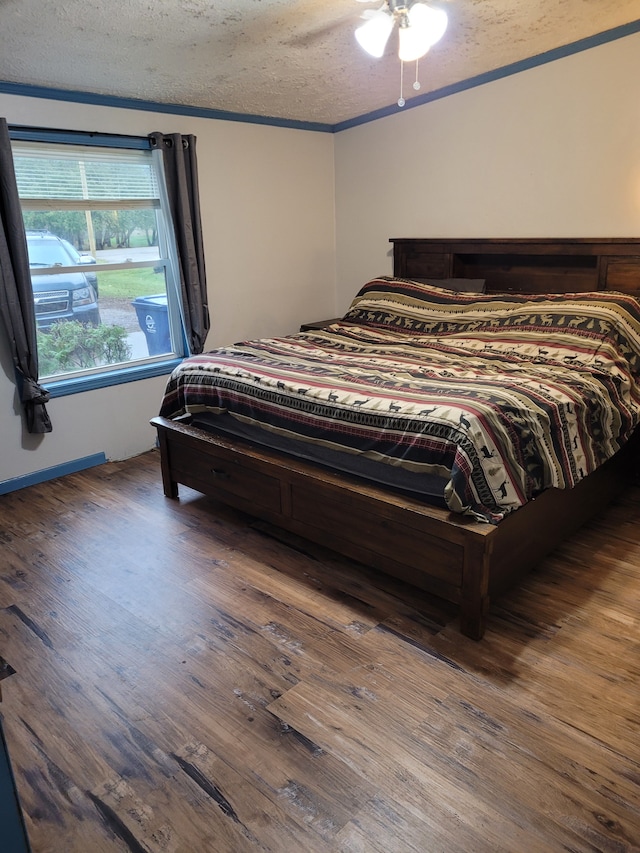 bedroom with dark hardwood / wood-style flooring and a textured ceiling