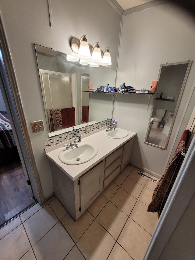 bathroom with vanity, tile patterned floors, and decorative backsplash