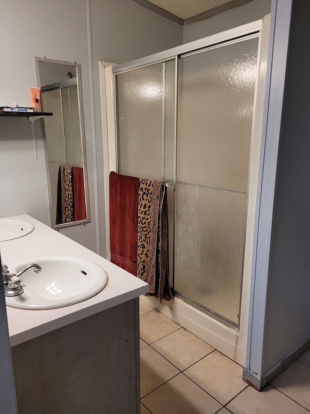 bathroom featuring an enclosed shower, vanity, and tile patterned floors