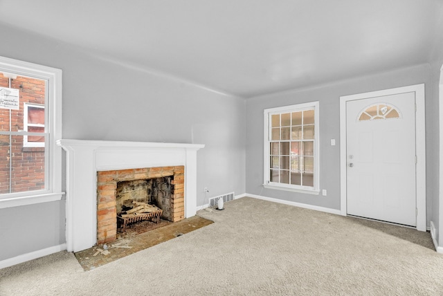 carpeted living room with a wealth of natural light and a fireplace