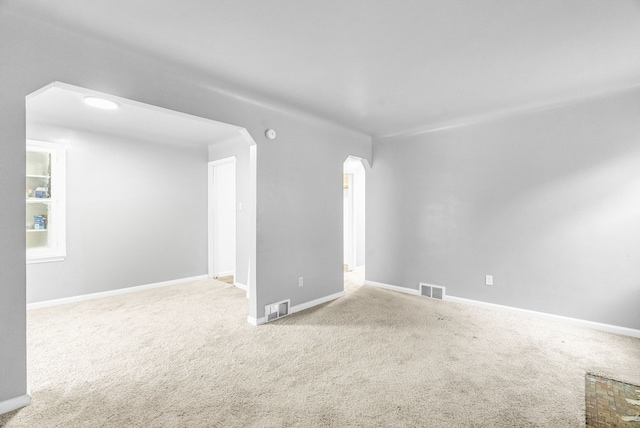 unfurnished room with light carpet