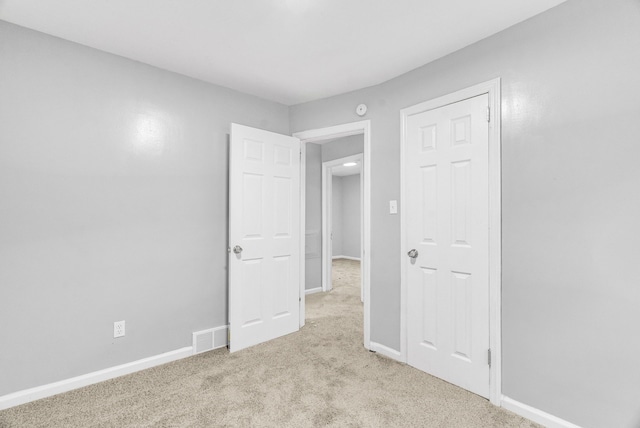 unfurnished bedroom with light carpet