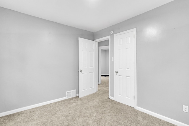 unfurnished bedroom featuring light colored carpet