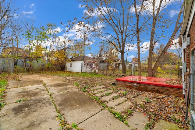 view of yard featuring an outbuilding and a patio