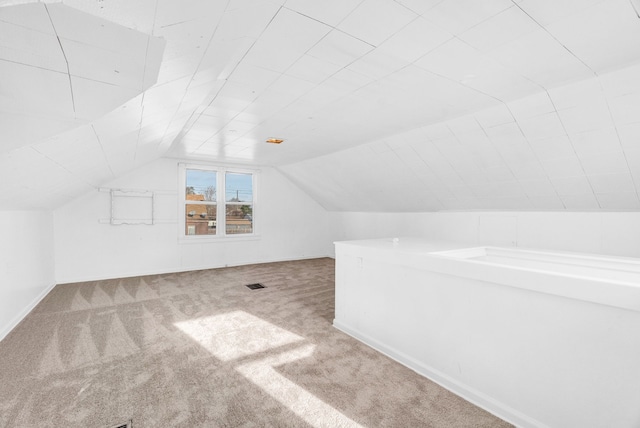 bonus room with carpet floors and lofted ceiling