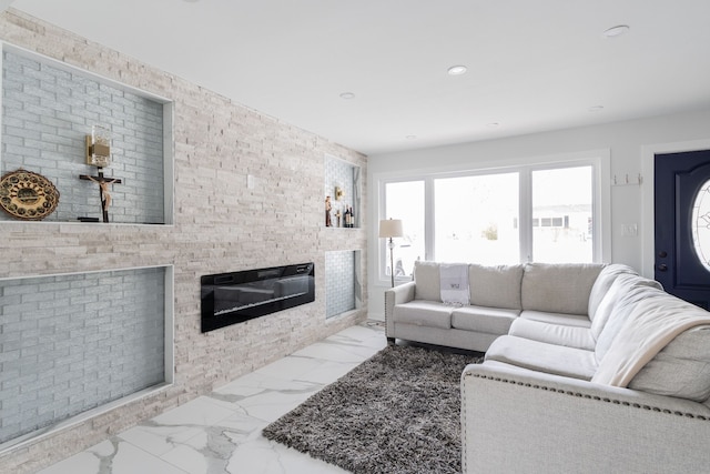 living room featuring a stone fireplace