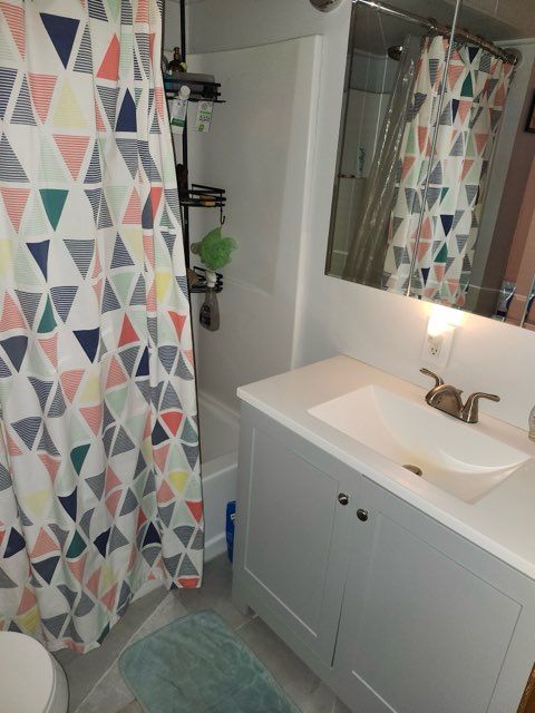 bathroom featuring tile patterned flooring, vanity, and toilet