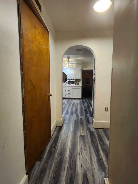 hallway with dark wood-type flooring