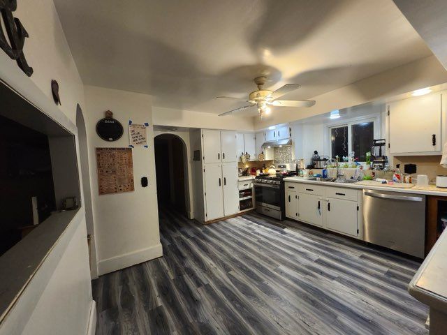 kitchen featuring white cabinets, sink, dark hardwood / wood-style floors, ceiling fan, and appliances with stainless steel finishes