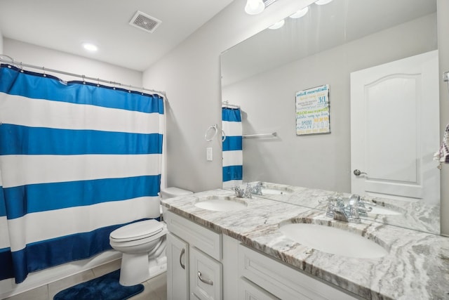 bathroom with toilet, vanity, tile patterned floors, and walk in shower