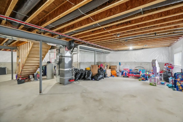 2785 Tulip Way, Commerce Twp, MI 48382 - basement featuring stairway, heating unit, and water heater