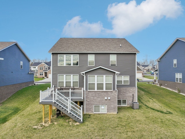 2785 Tulip Way, Commerce Twp, MI 48382 - back of house with a deck, a yard, brick siding, and stairway