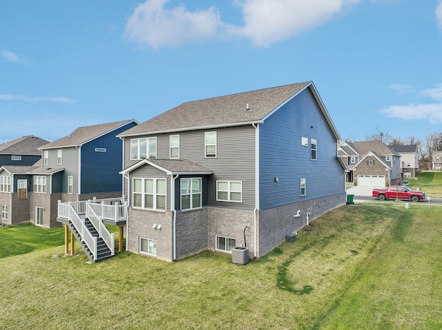 2785 Tulip Way, Commerce Twp, MI 48382 - rear view of property with a residential view, brick siding, a lawn, and a wooden deck