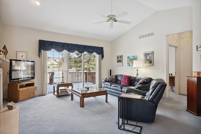 carpeted living room featuring ceiling fan and high vaulted ceiling