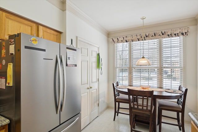 kitchen featuring stainless steel refrigerator, light stone countertops, decorative light fixtures, and ornamental molding